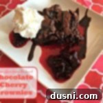 chocolate cherry brownie on a white plate with text "Chocolate Cherry Brownies"