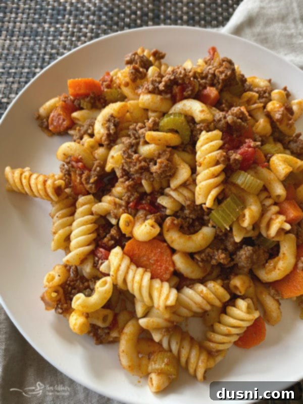 A bowl of Classic American Goulash with pasta, ground beef, and vegetables