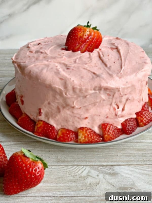 Velvet Strawberry Dream 2 Delicious Strawberry Cake adorned with fresh berries, showcasing its vibrant pink frosting and moist layers.