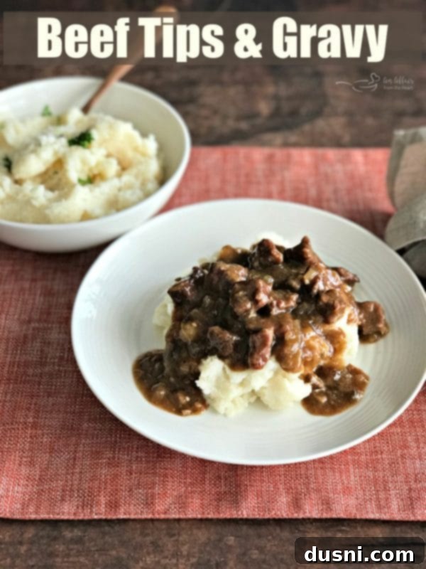Tender Beef Tips in Rich Gravy 13 Hero shot of a bowl filled with Beef Tips & Gravy and mashed potatoes, emphasizing pure comfort.