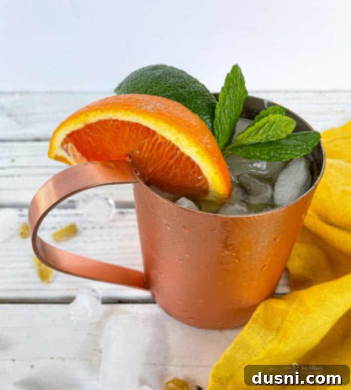 Close-up of a Kentucky Mule in a copper mug with garnishes