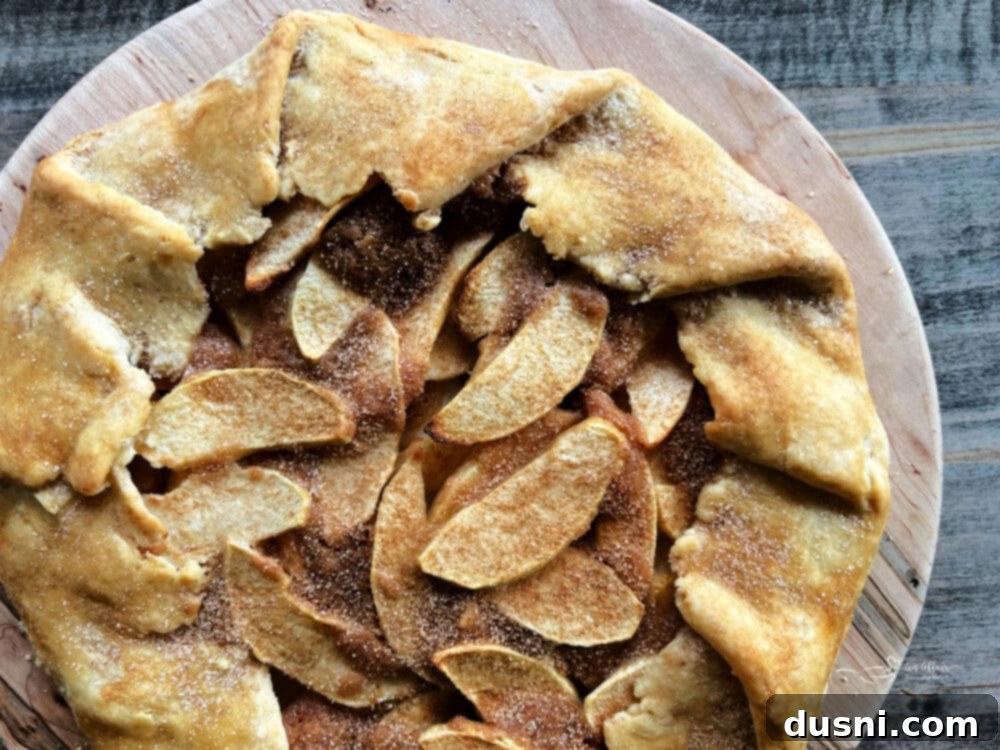 Close-up of apple slices arranged on a pie crust for crostata