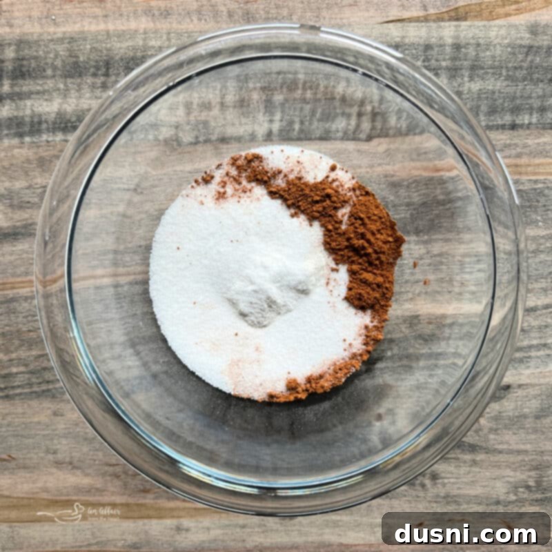 Mixing flour, sugar, salt, and apple pie spice in a bowl