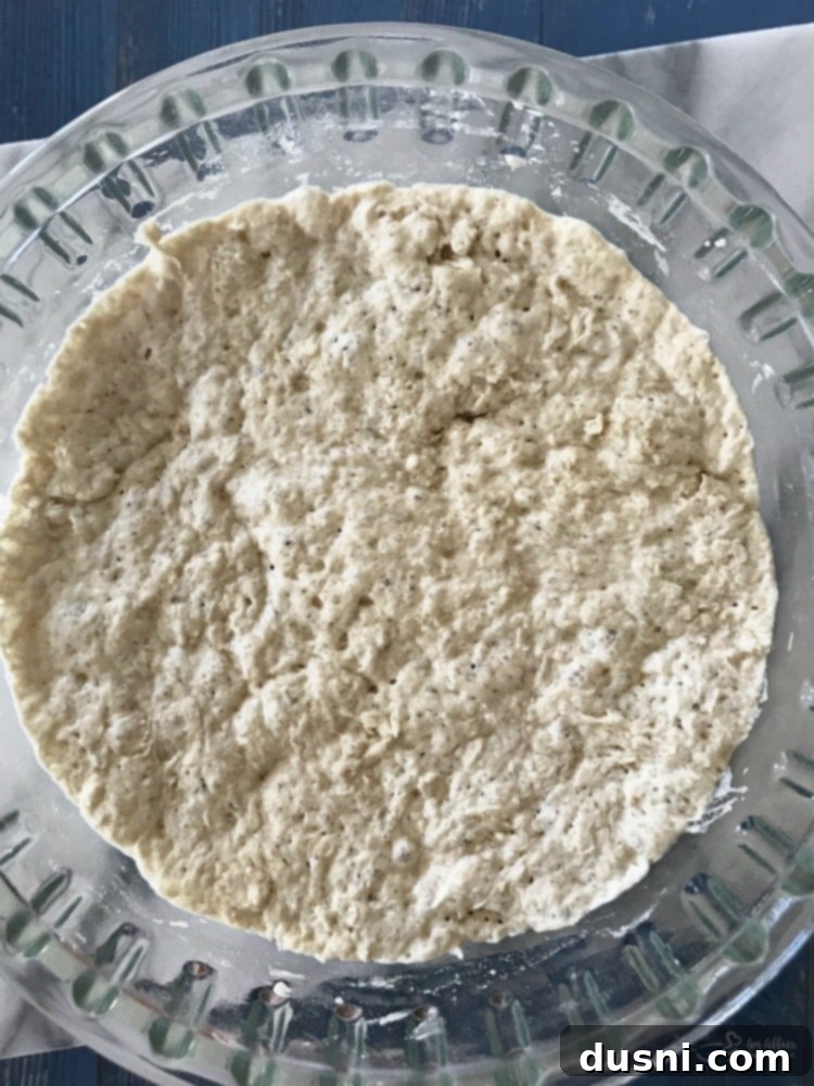 Ingredients for No Knead Crusty Dutch Oven Bread laid out: flour, salt, yeast, and a measuring cup of water.