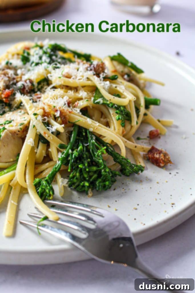 A beautifully presented bowl of creamy chicken carbonara with fresh parsley garnish, ready to be served.