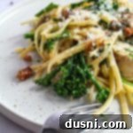Extreme close up of Chicken Carbonara on a white plate