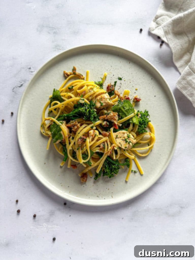 Close-up of golden-brown chicken pieces cooking in a cast iron skillet with olive oil.