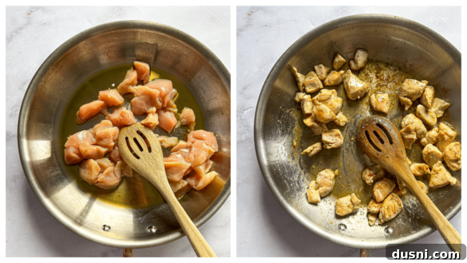 Close-up of chicken cubes being sautéed in olive oil in a large skillet.