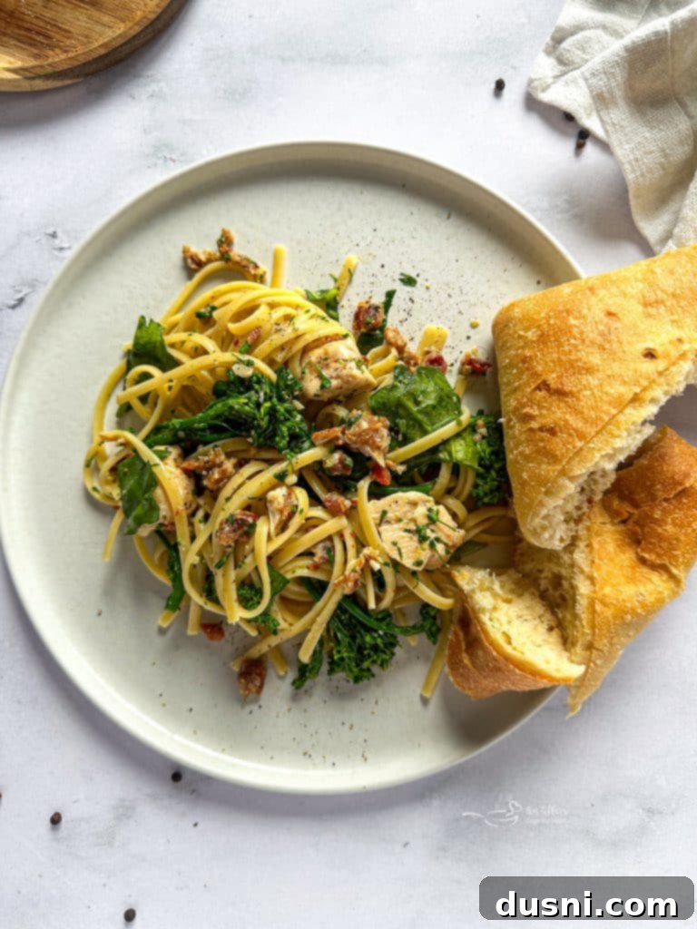 A prepared plate of creamy chicken carbonara, garnished with fresh parsley.