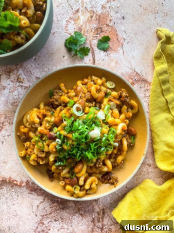 Hearty One-Pan Chili Mac 2 Chili Mac Skillet served warm, topped with fresh herbs.