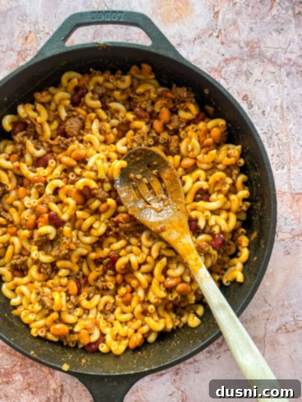 Hearty One-Pan Chili Mac 11 Melted American cheese topping the Chili Mac Skillet, ready to be mixed.