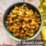 Hearty One-Pan Chili Mac 21 Chili Mac in a bowl with a yellow napkin along the side