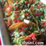 Baked Shredded Beef Tacos served on a white platter with text "baked shredded beef tacos"