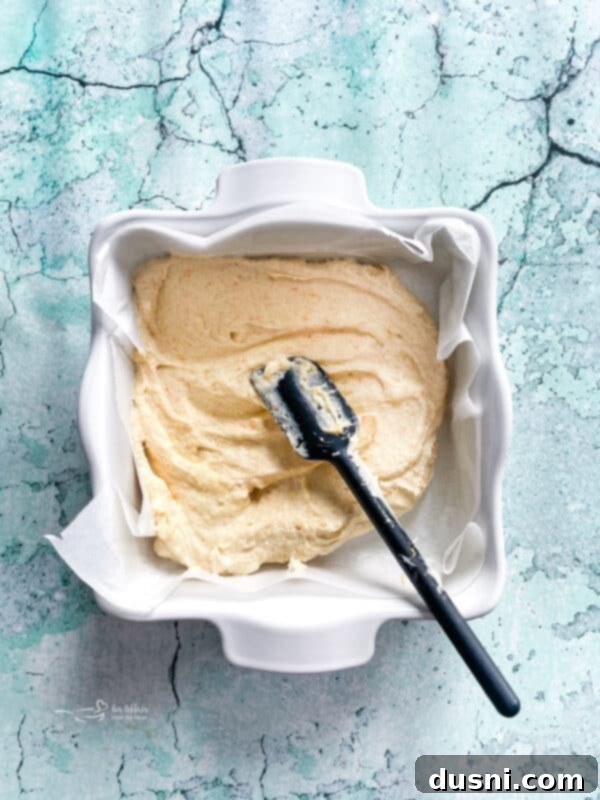 Sunshine Orange Bars 8 Spreading Fresh Orange Bars batter into a baking dish.