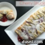 Overhead of strudel on a white serving tray and a slice on a white plate with text "cherry strudel"