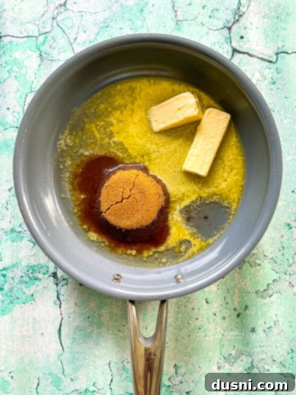 Melting butter in a skillet for the pineapple topping