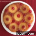 The Ultimate Homemade Pineapple Upside Down Cake 24 Overhead of From Scratch Pineapple Upside Down Cake on a whit plate
