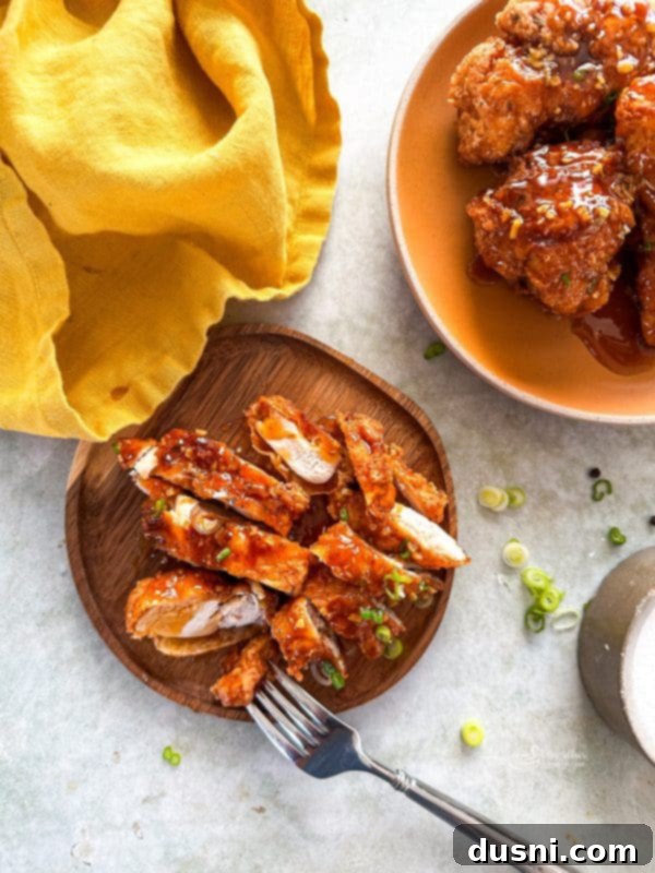 Honey-Glazed Crispy Fried Chicken 2 Crispy Honey Fried Chicken on a platter, garnished with green onions