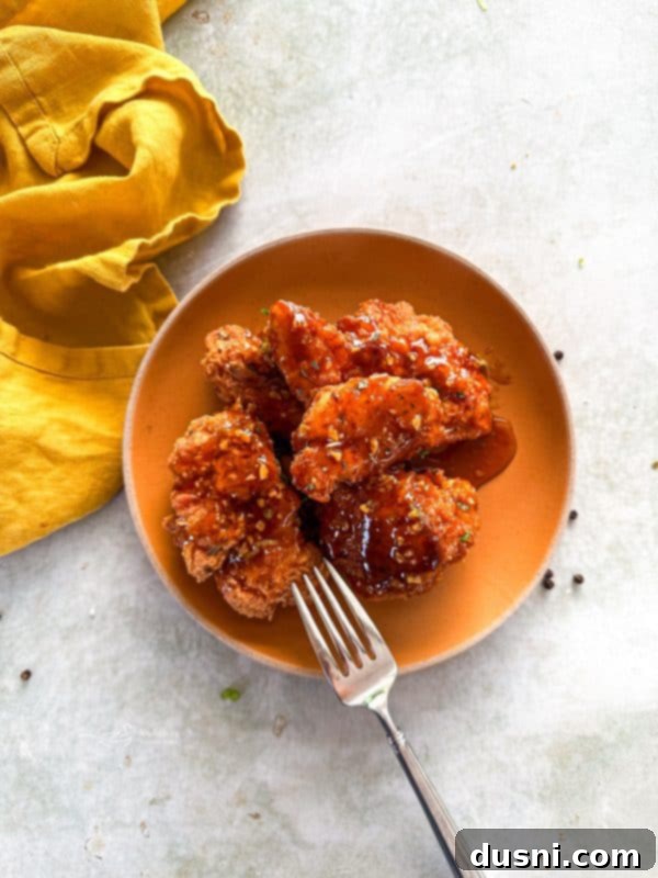 Honey-Glazed Crispy Fried Chicken 3 Platter of golden brown honey fried chicken pieces.