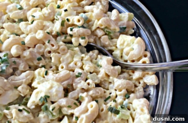 A classic bowl of creamy macaroni salad, ready to be served at a BBQ.