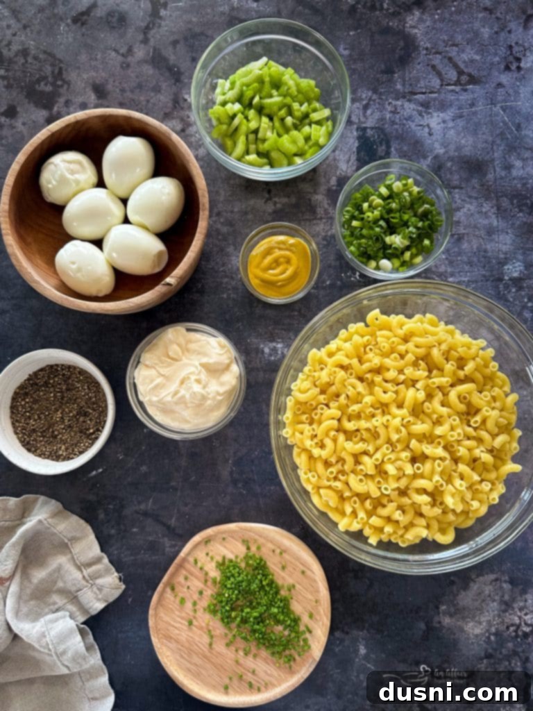 A large serving bowl filled with homemade macaroni salad, glistening with creamy dressing.