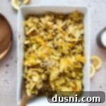 Scooping the Tuna Tetrazzini out of the casserole dish.