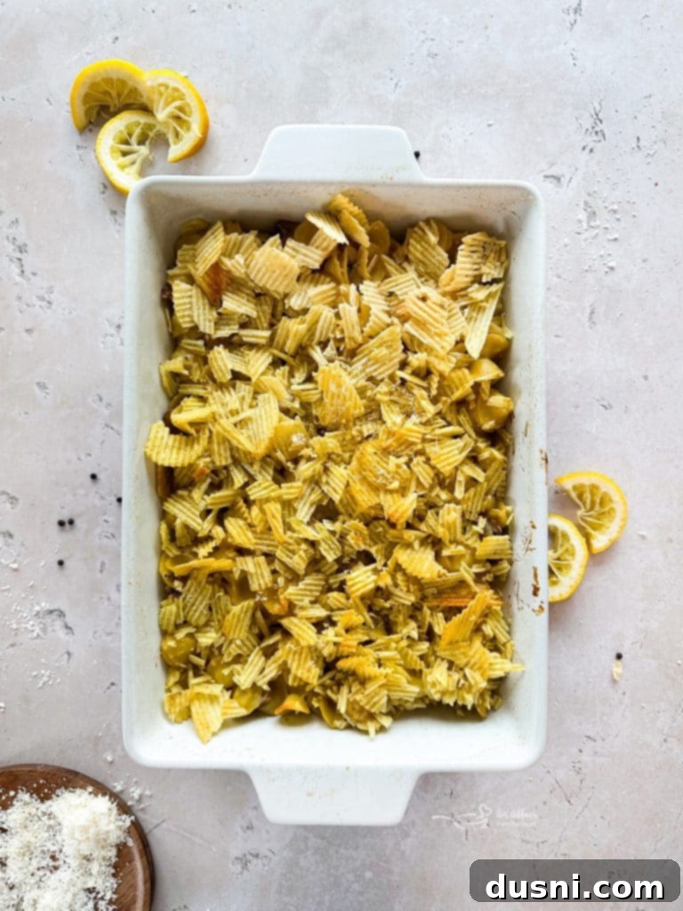 Tuna Tetrazzini Casserole in baking dish, topped with crushed chips, ready for oven
