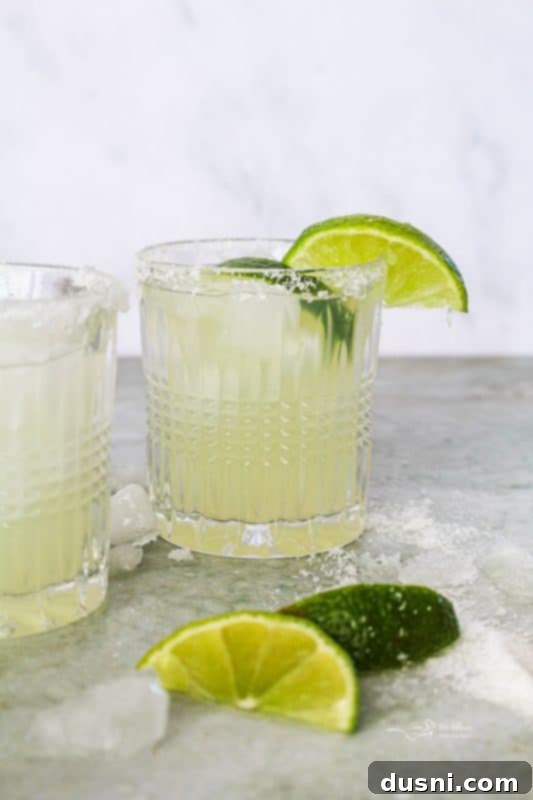 A refreshing El Bee's Margarita with a salted rim and lime wedge