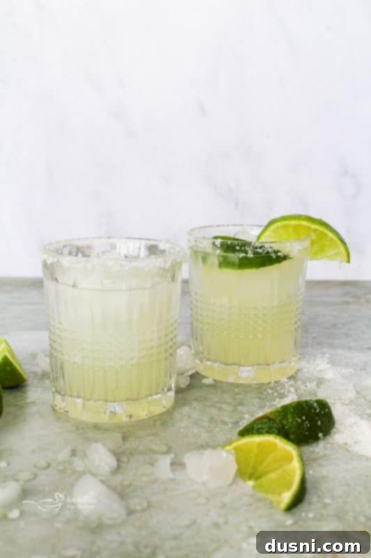 Two El Bee's Margaritas garnished with limes