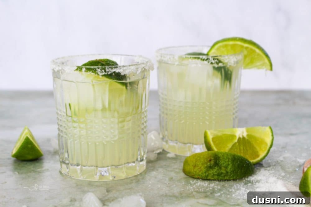 A person pouring an El Bee's Margarita into a glass