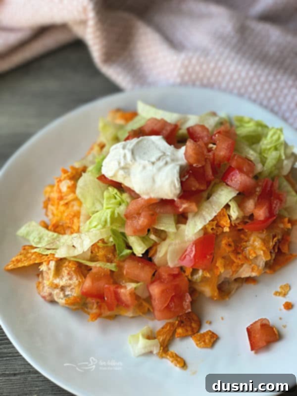 Ultimate Doritos Taco Salad 13 Chicken & Doritos Casserole on a white plate, showcasing another creative and delicious use for Doritos.