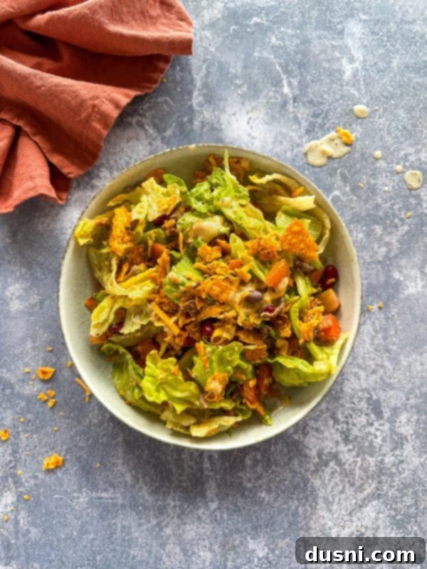 Ultimate Doritos Taco Salad 3 A close-up shot of the fresh ingredients used in Doritos Taco Salad before mixing, including lettuce, cheese, and kidney beans.