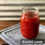 The Perfect Homemade BBQ Elixir 10 Jar of Homemade Barbecue Sauce on a grey potholder