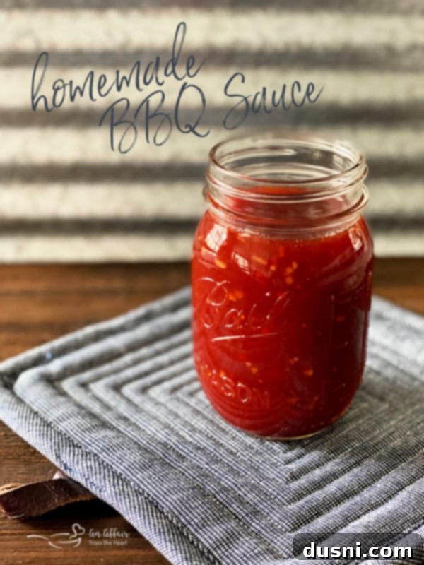 Homemade BBQ Sauce in a mason jar with a spoon, ready to be served