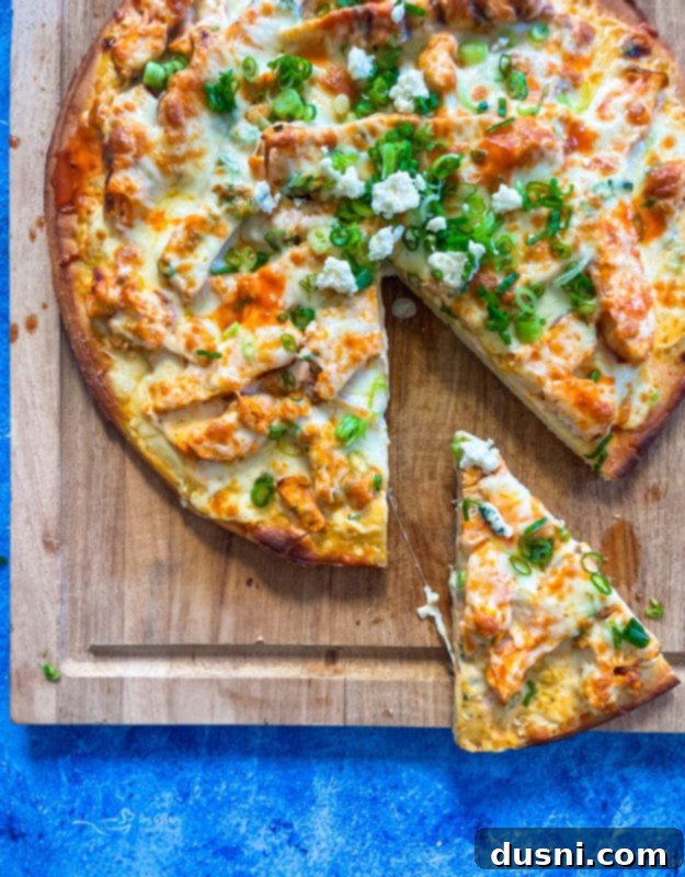 Delicious Buffalo Chicken Pizza sliced on a wooden board