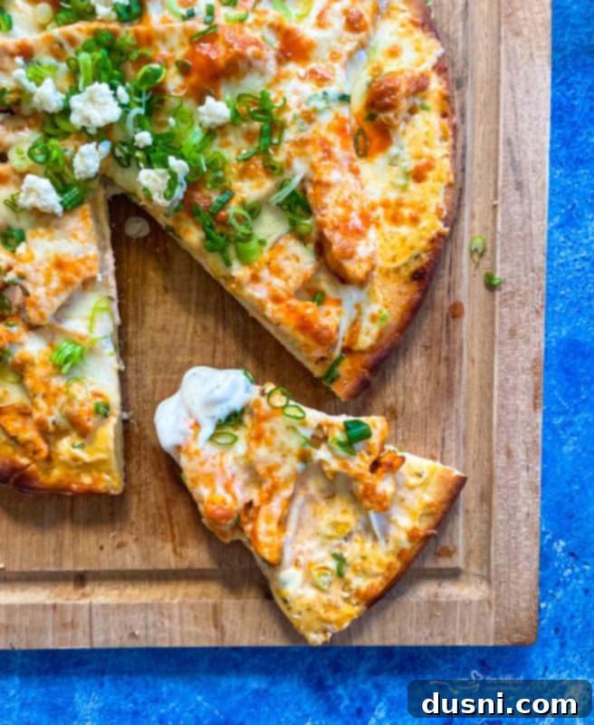Another angle of the Buffalo Chicken Pizza on a wooden board