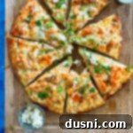 A sliced buffalo chicken pizza on a wood platter