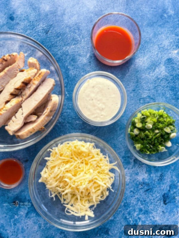 Closeup of buffalo chicken pizza slice being lifted