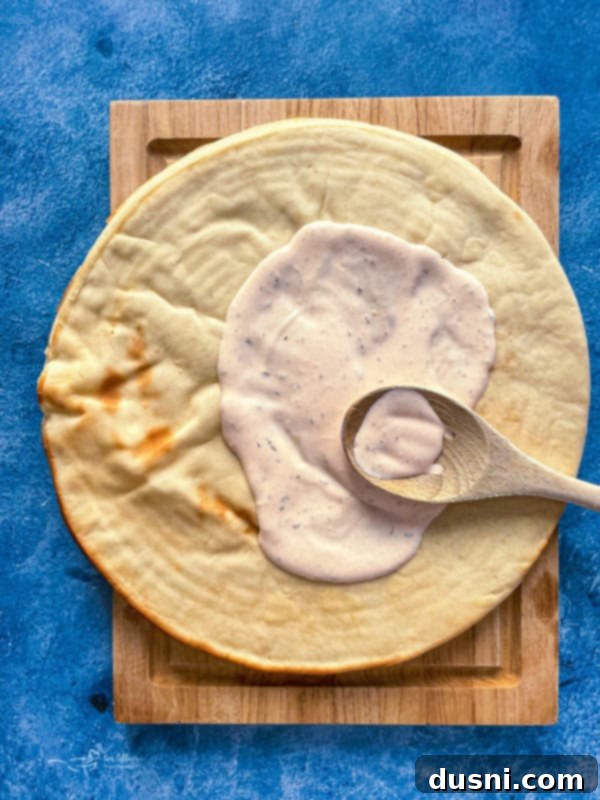 Chicken pieces being tossed in hot wing sauce