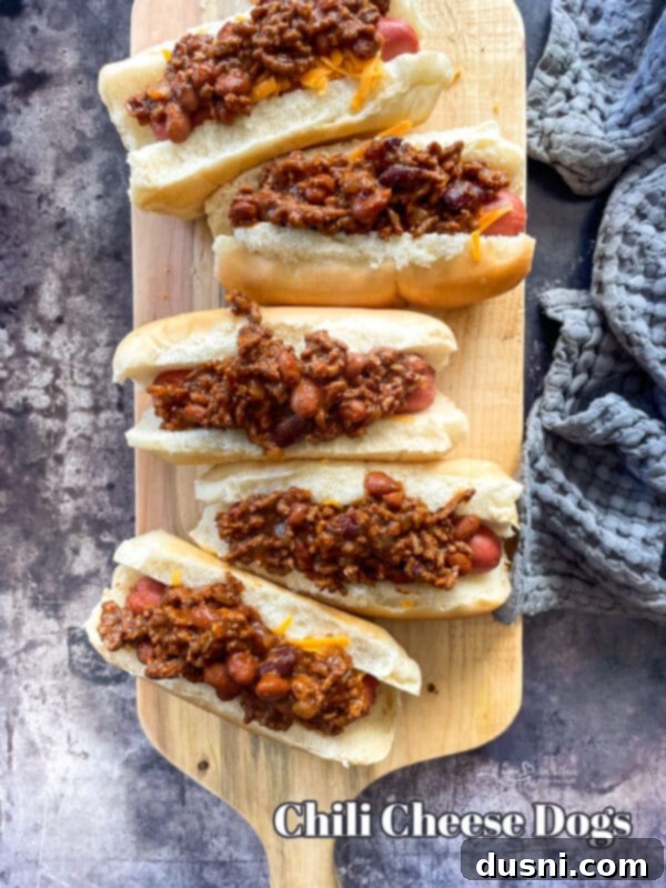 A plate of two chili cheese dogs with fries