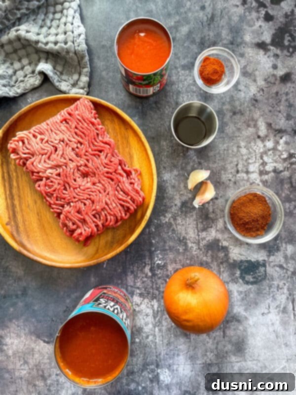 Assembled chili cheese dogs with melted cheese and hot chili