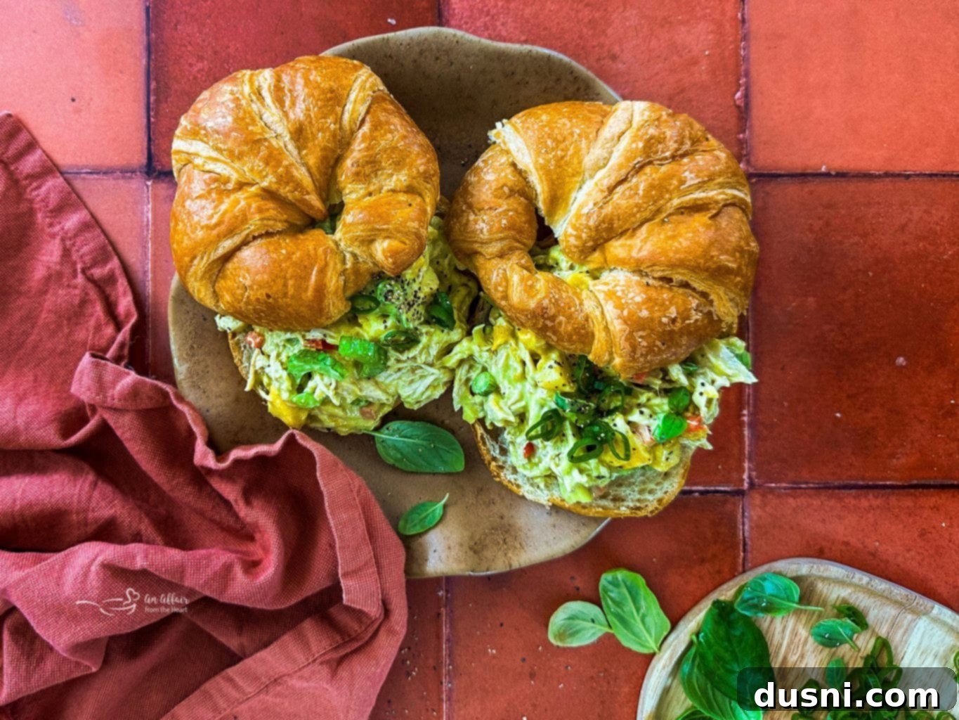 Two Croissants stuffed with Peach Basil Chicken Salad.