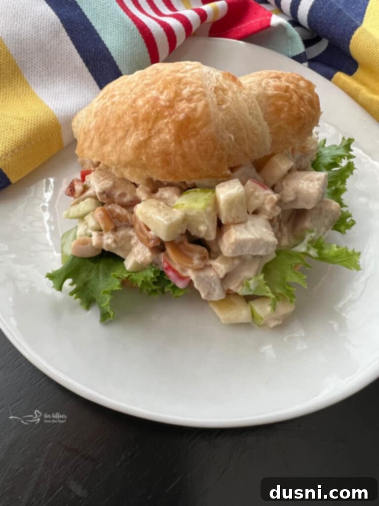 Apple chicken salad sandwich on a white plate