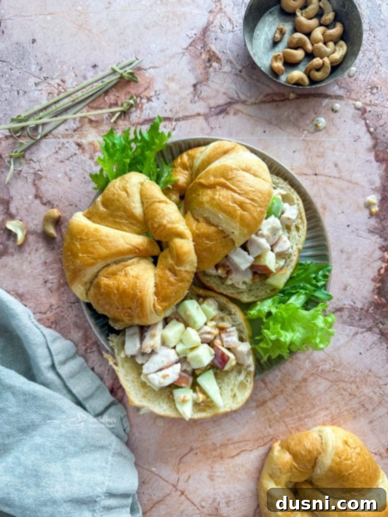 A bowl of Apple Chicken Salad being served on a piece of toasted bread.