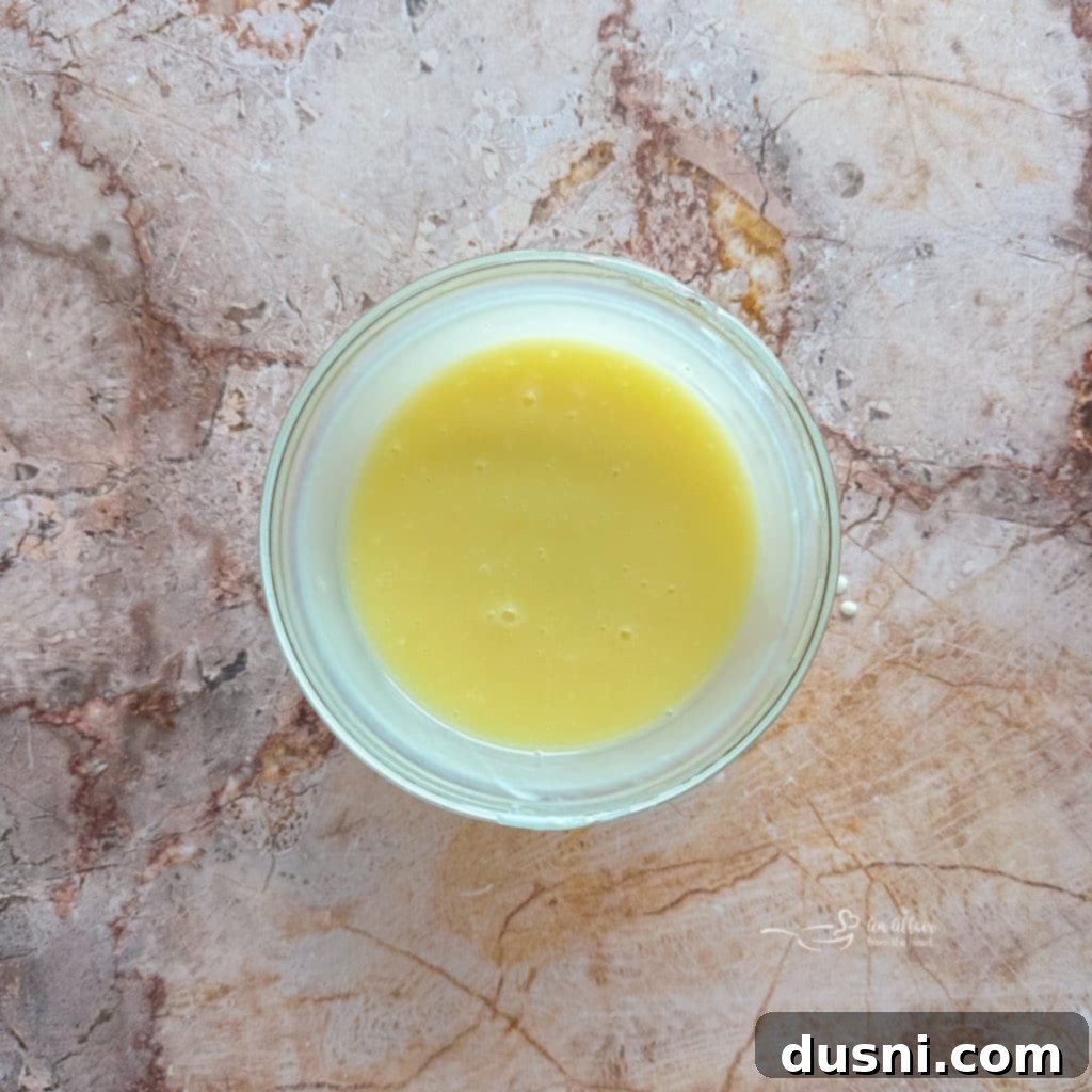 Whisking dressing ingredients in a small bowl.