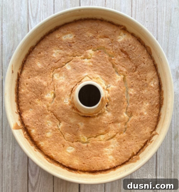 Pineapple angel food cake batter being poured into an ungreased tube pan