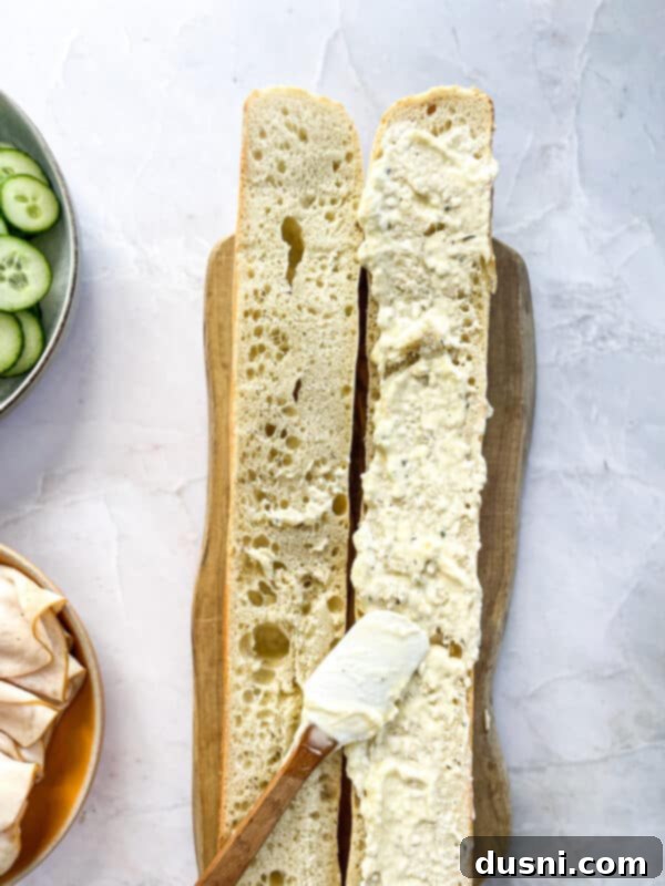 Step 5: Spreading the ranch cream cheese mixture onto the baguette half