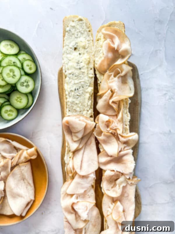 Step 6: Layering thinly sliced deli turkey over the ranch spread