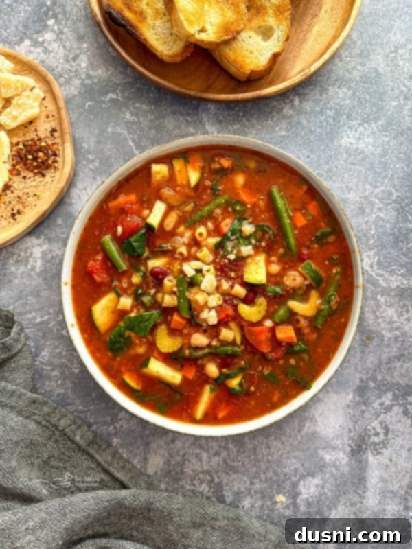 Simmered Garden Minestrone 4 Crock Pot Minestrone Soup with a wooden spoon.