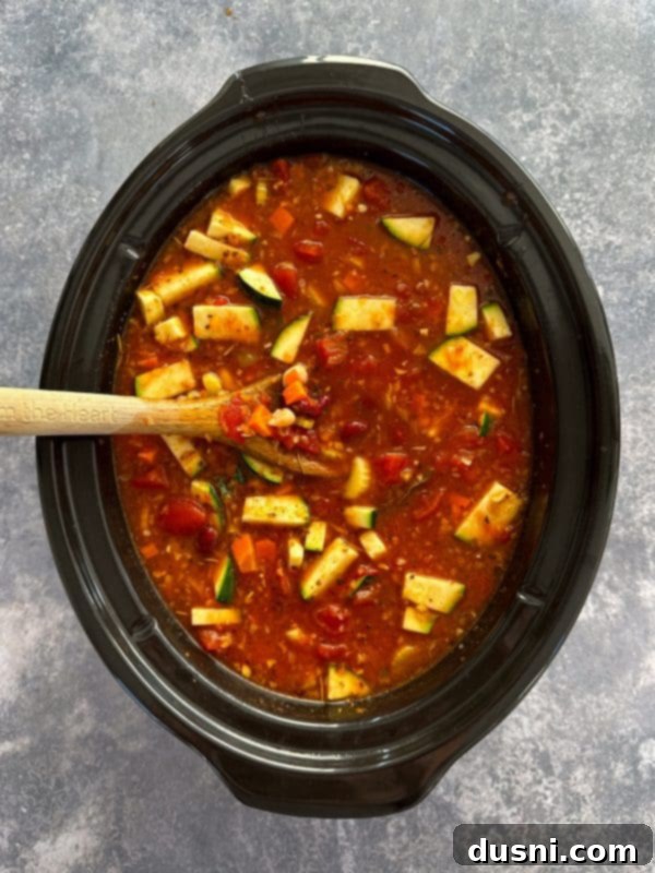 Simmered Garden Minestrone 9 Second step of cooking crock pot minestrone: adding beans, pasta, and zucchini.